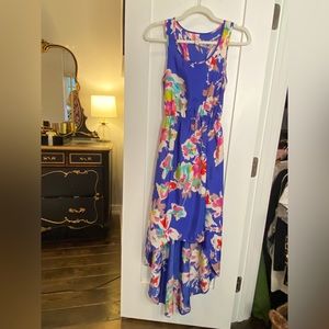 Darling floral high/low dress featuring racer back behind.